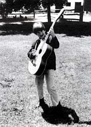 young Mark Cosgrove with acoustic guitar